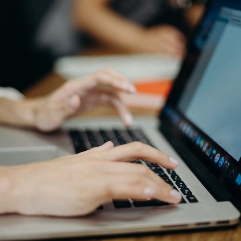 a person typing on a laptop