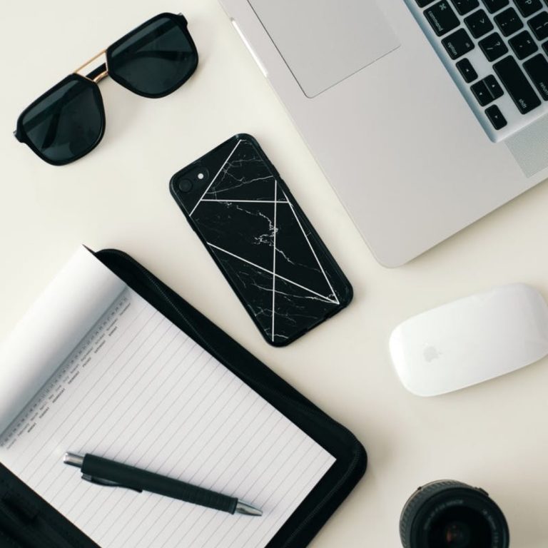 a laptop and sunglasses on a table