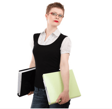 a woman holding files and looking at the camera