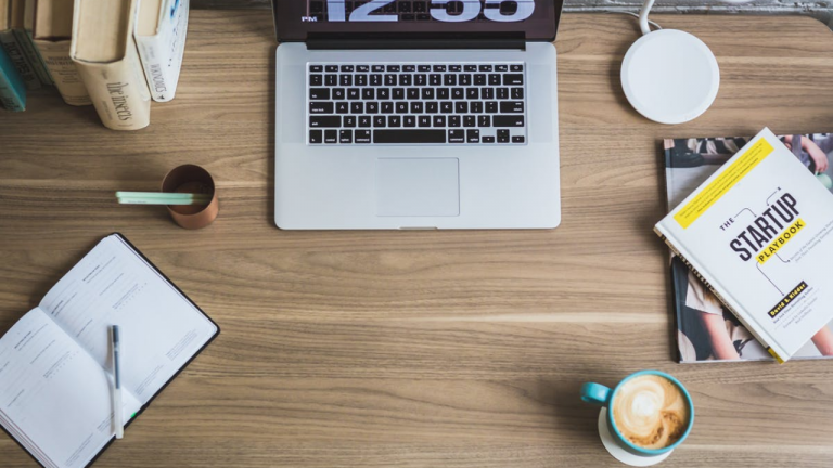 a laptop and coffee on a table