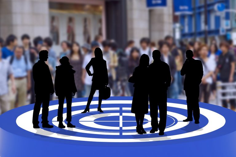 a group of people standing on a blue and white target