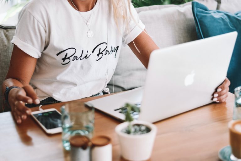 a woman sitting at a table with a laptop