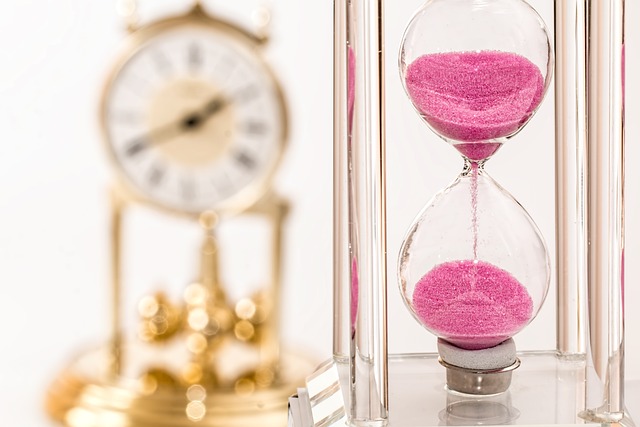 a hourglass with pink sand in the middle