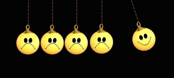 a group of yellow balls with sad faces
